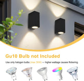 Two black outdoor wall lights on a building with GU10 bulb compatibility information.